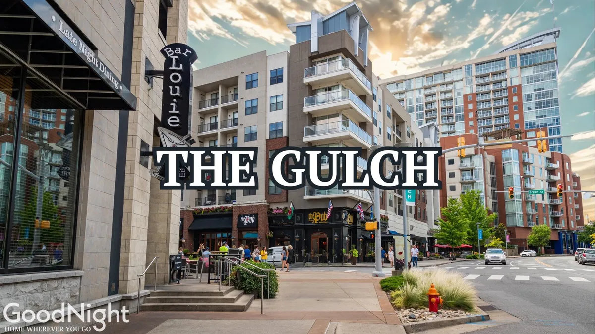 The image captures Bar Louie and The Gulch sign against a backdrop of modern apartments and a bustling, busy street. Outdoor diners, foot traffic, and artistic urban touches convey the lively, social energy of downtown Nashville.