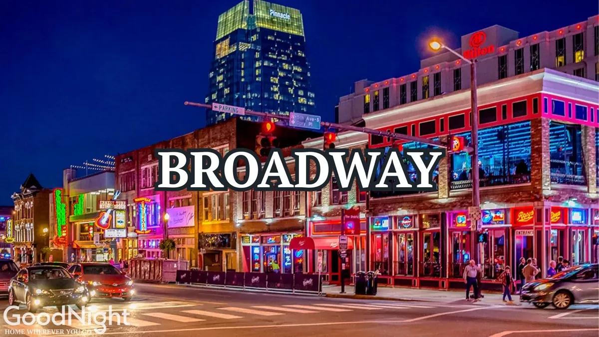 This image features a lively nighttime street scene with vibrant neon signs, a bustling sidewalk, and colorful buildings. The area is filled with people enjoying the energetic atmosphere, hinting at live music venues and a thriving nightlife.