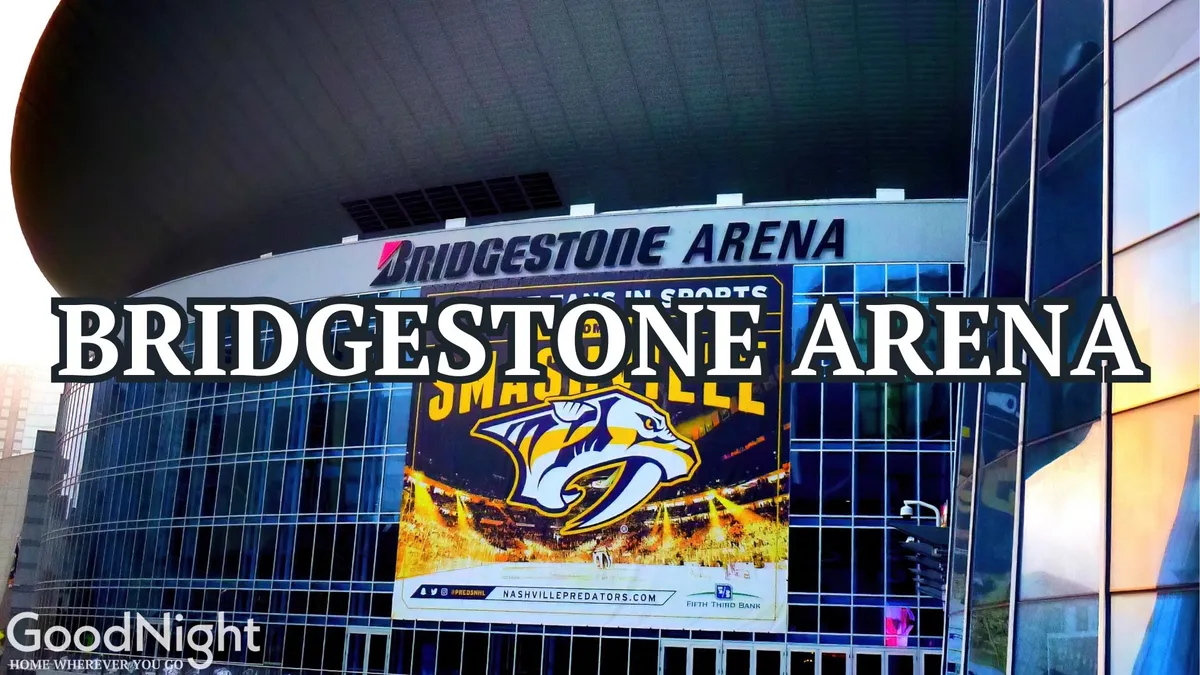 The exterior view of Bridgestone Arena features prominent signage and banners, set against modern architectural lines. The area buzzes with anticipation for hockey games, concerts, and community events, exemplifying the lively entertainment options in the heart of downtown Nashville.