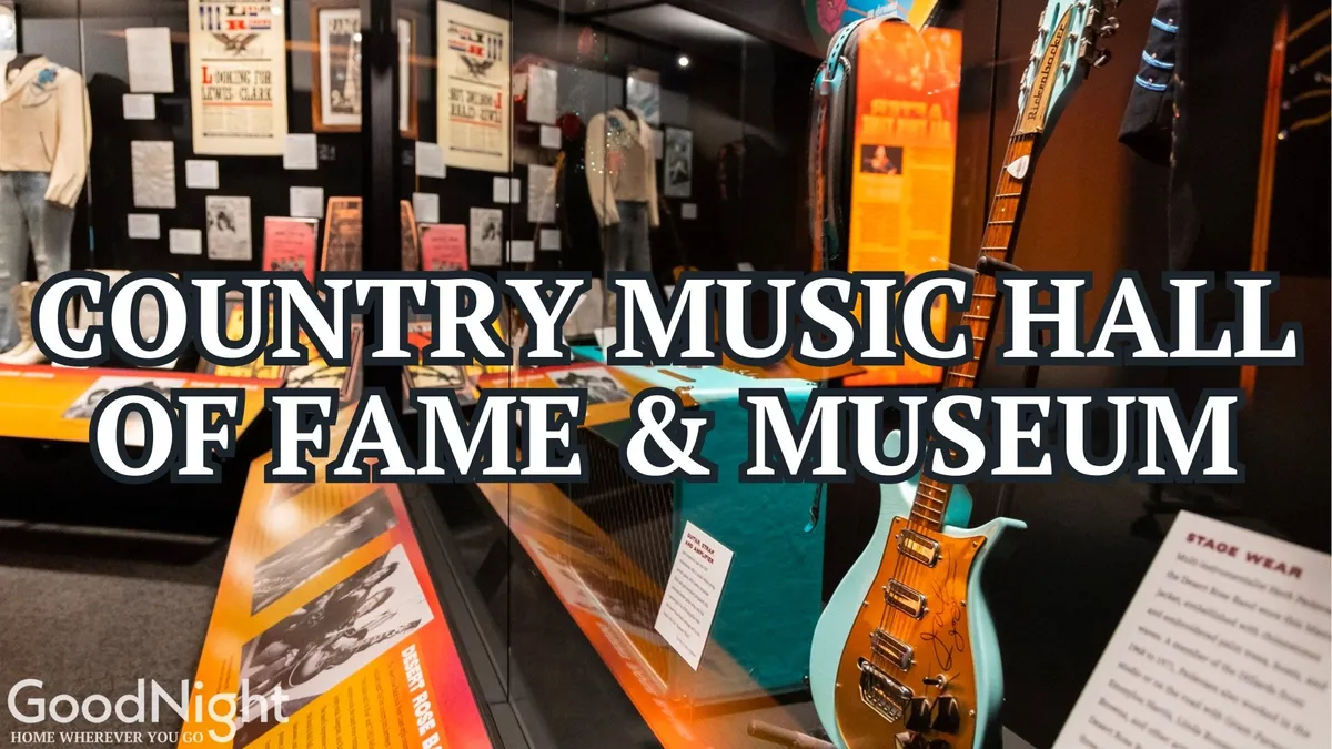 An interior view of the Country Music Hall of Fame, showcasing a guitar, iconic stage wear exhibits, and various informational displays. The atmosphere is nostalgic yet engaging, offering educational and interactive elements perfect for family exploration.